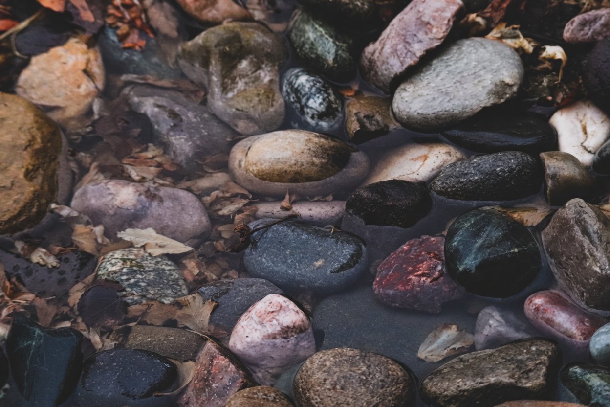 Smooth river pebbles and stones under water